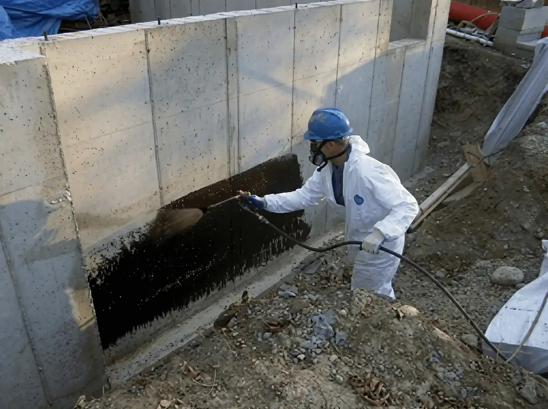 Professional waterproofing the exterior walls of the basement in Santa Ana, CA