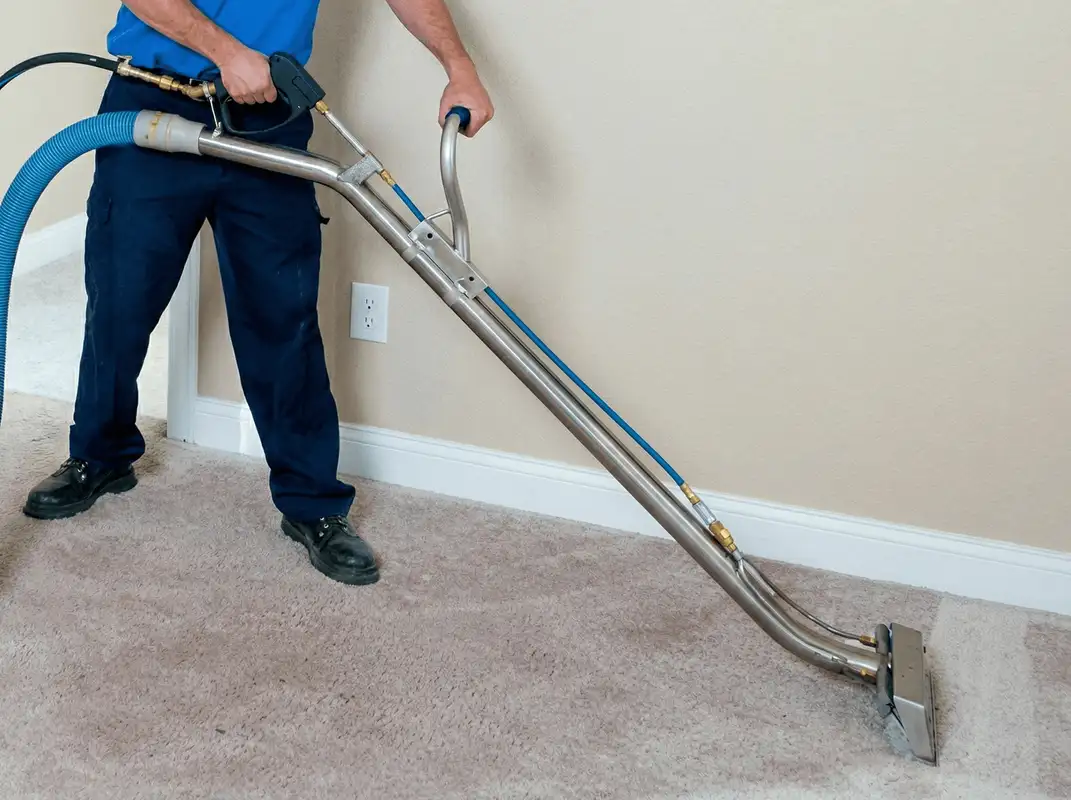 Professional operating a liquid removal machine on a carpeted floor in Santa Ana, CA